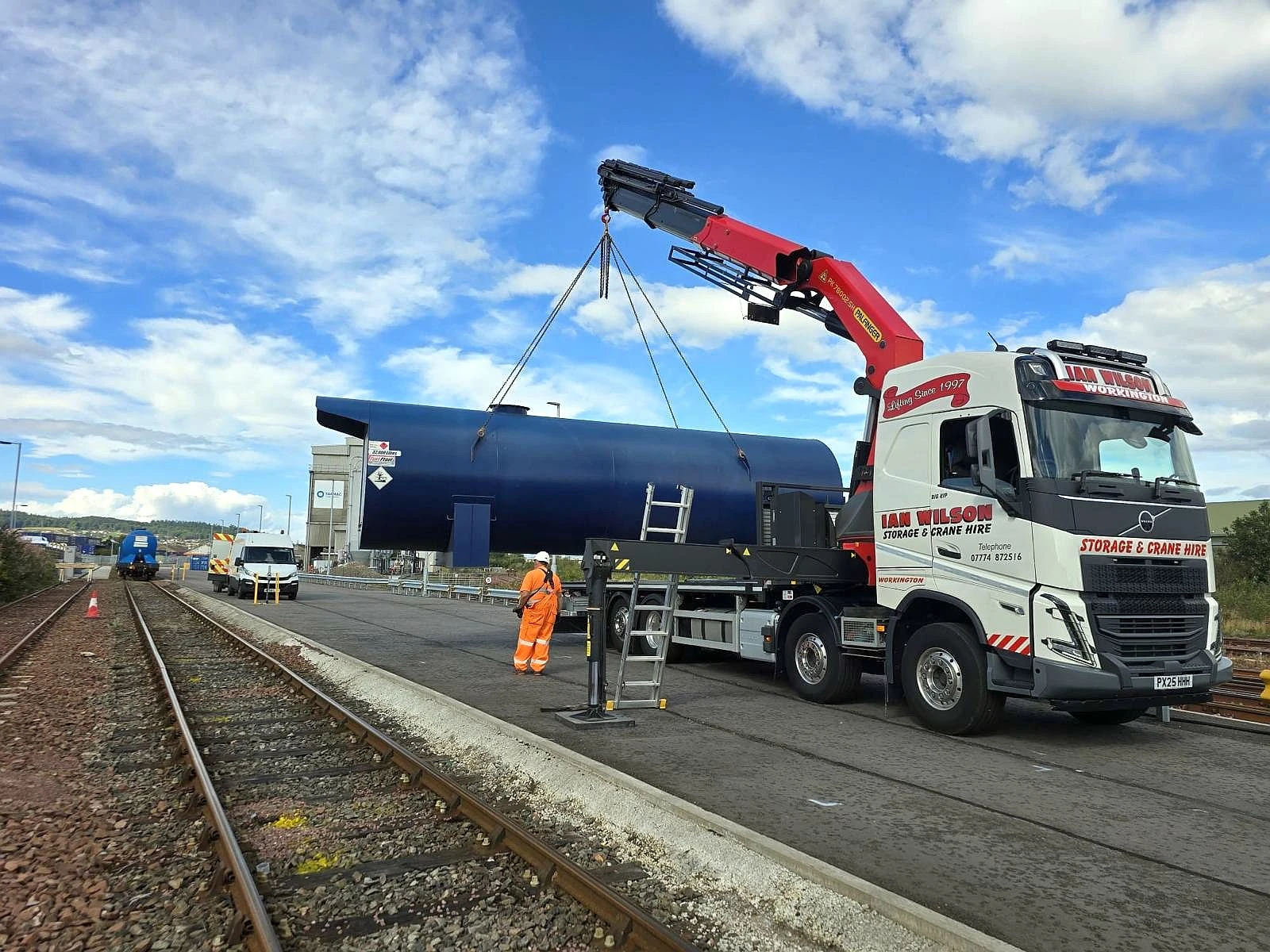 HIAB Lorry hire collaborating with rail freight contractor lifting a tanker unit onto railway stock in Whitehaven, Cumbria
